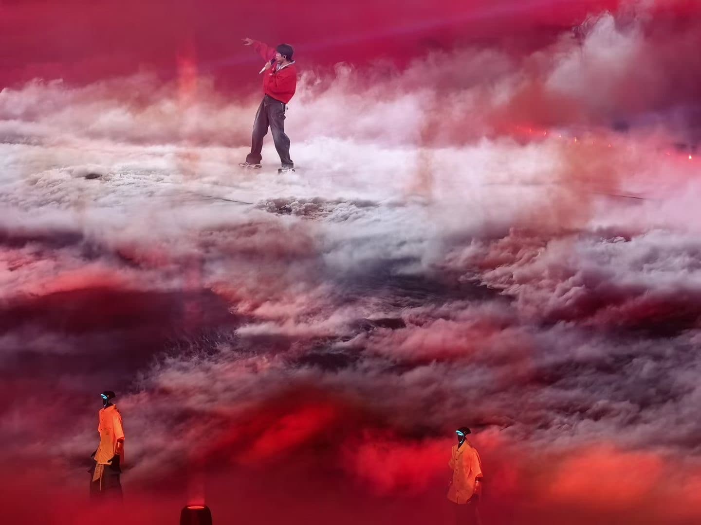 Robot fleet performing on stage with dramatic red lighting